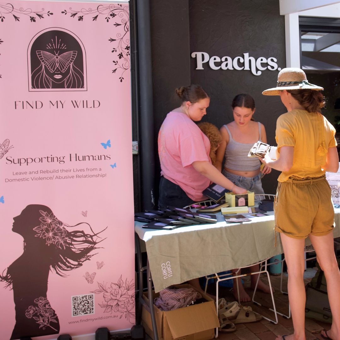 Find My Wild stall with banner and merchandise
